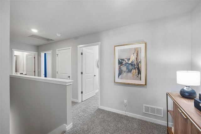 corridor featuring baseboards, visible vents, carpet flooring, and an upstairs landing