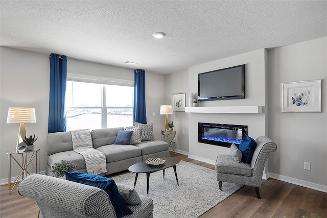 living room featuring dark wood-type flooring and a textured ceiling