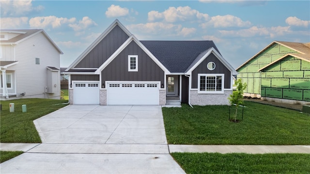 view of front of home with a garage and a front lawn