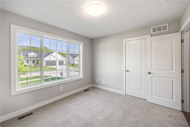 unfurnished bedroom featuring a closet and carpet floors