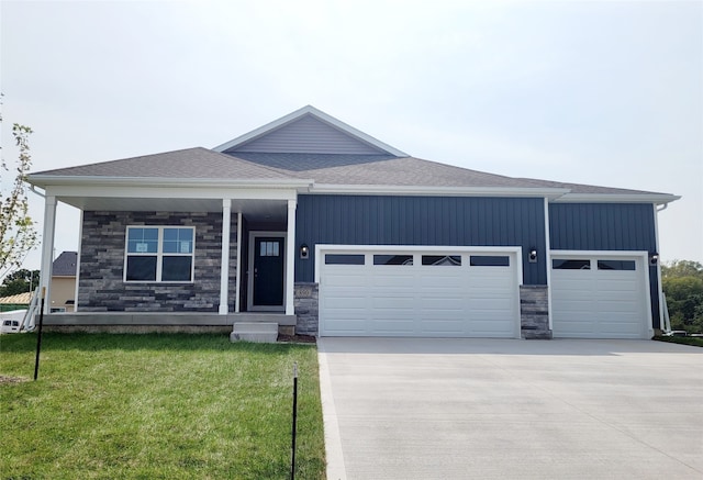 view of front of home featuring a garage and a front lawn