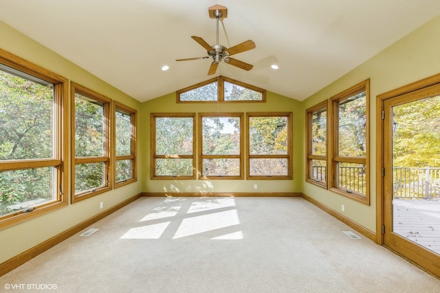 unfurnished sunroom with lofted ceiling, ceiling fan, and a wealth of natural light