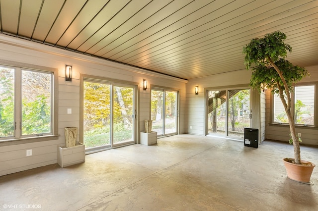 unfurnished sunroom with wooden ceiling