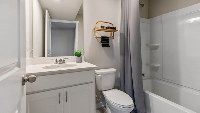 full bathroom with shower / bath combination with curtain, large vanity, and toilet