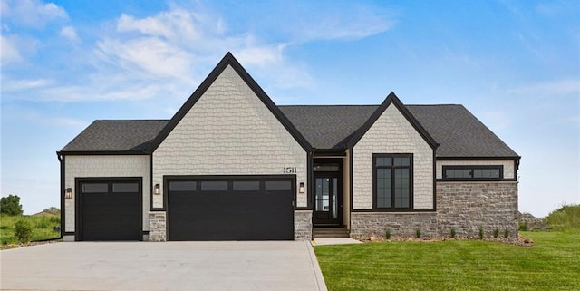 view of front of property featuring a garage and a front lawn