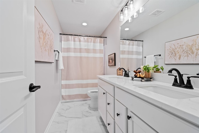 bathroom with toilet and vanity