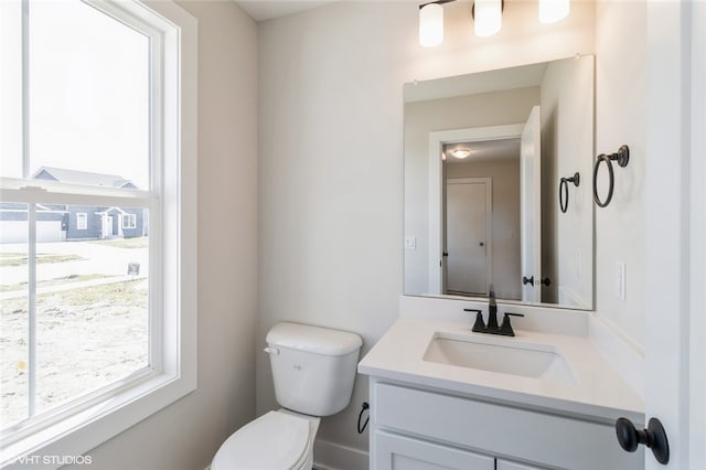 bathroom with toilet and vanity