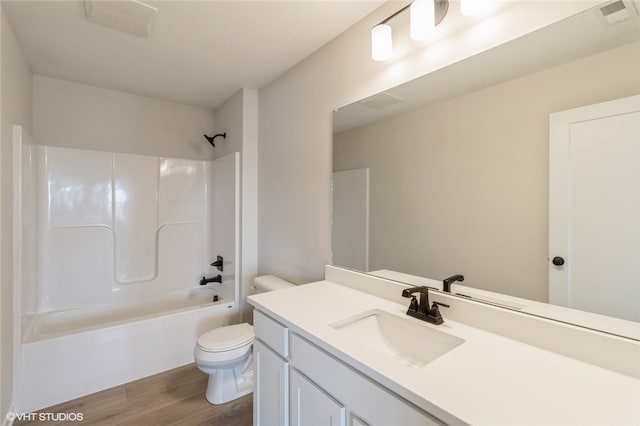 full bathroom featuring toilet, vanity, wood-type flooring, and shower / bathtub combination