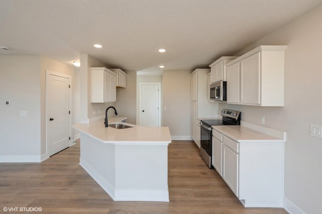 kitchen featuring sink, appliances with stainless steel finishes, white cabinetry, and light hardwood / wood-style floors