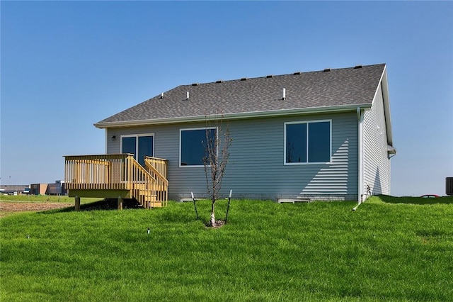 back of house with a deck and a yard