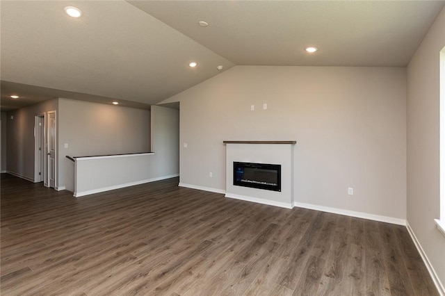 unfurnished living room featuring dark hardwood / wood-style floors and vaulted ceiling