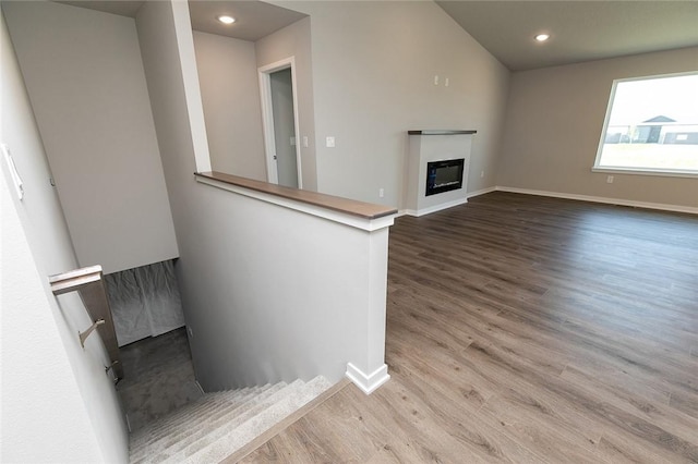 interior space featuring light hardwood / wood-style floors and lofted ceiling