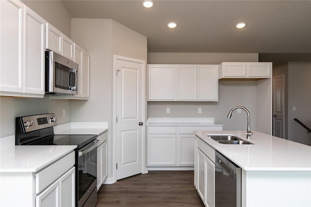 kitchen featuring sink, white cabinetry, stainless steel appliances, and a kitchen island with sink