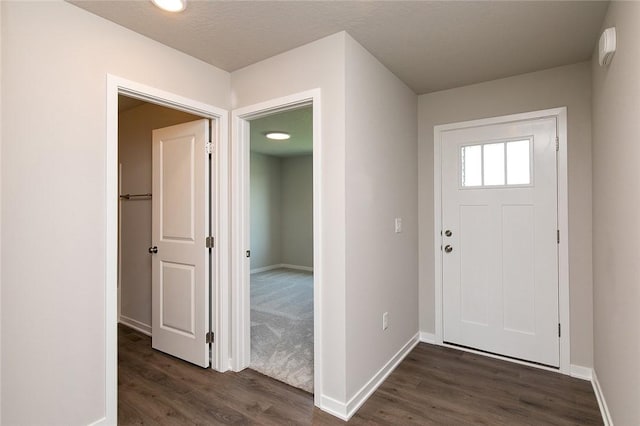 entryway featuring a textured ceiling and dark hardwood / wood-style floors