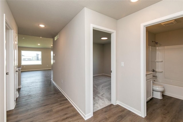 corridor with dark wood-type flooring