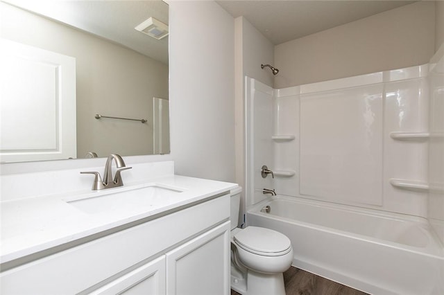 full bathroom with wood-type flooring, vanity, bathing tub / shower combination, and toilet