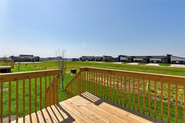 wooden terrace featuring a lawn