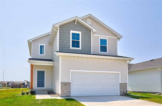 view of front of house with a front lawn and a garage