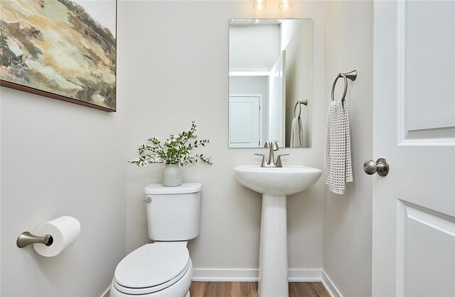 bathroom featuring hardwood / wood-style floors and toilet