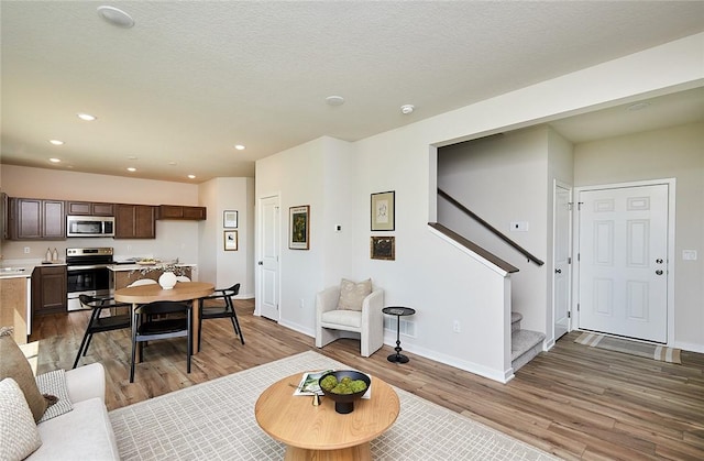 living room featuring a textured ceiling and hardwood / wood-style flooring