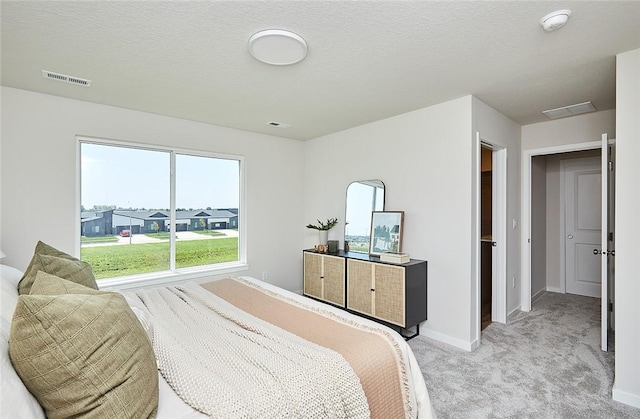 carpeted bedroom with a textured ceiling