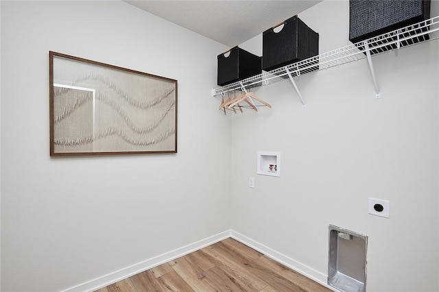 laundry room with a textured ceiling, electric dryer hookup, washer hookup, and hardwood / wood-style flooring