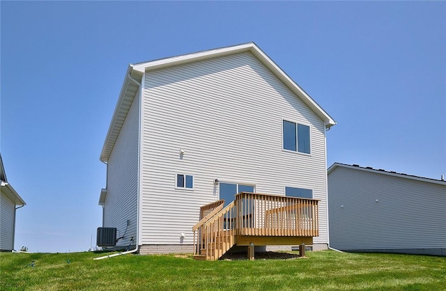 rear view of house featuring a lawn, a wooden deck, and central AC unit