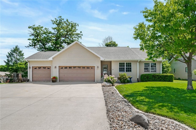 ranch-style house featuring a garage and a front yard