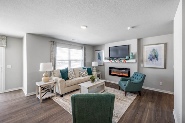 living room featuring dark wood-type flooring and a textured ceiling