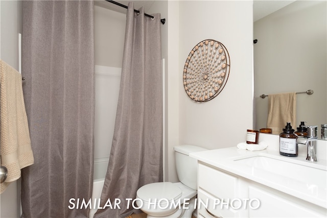 bathroom featuring toilet, shower / tub combo, and vanity