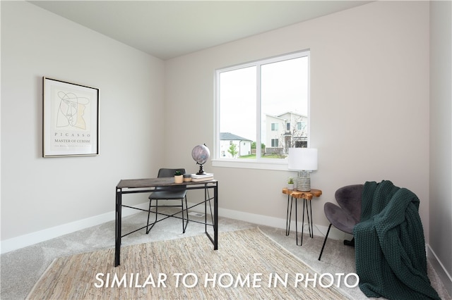 office area featuring light carpet and baseboards