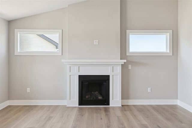 unfurnished living room featuring light hardwood / wood-style floors and lofted ceiling