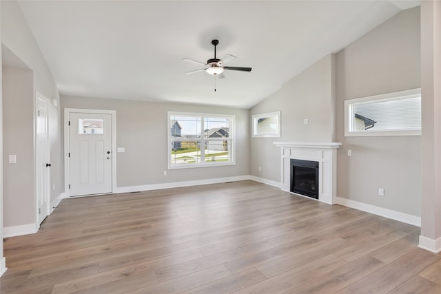 unfurnished living room featuring vaulted ceiling, ceiling fan, and light hardwood / wood-style flooring