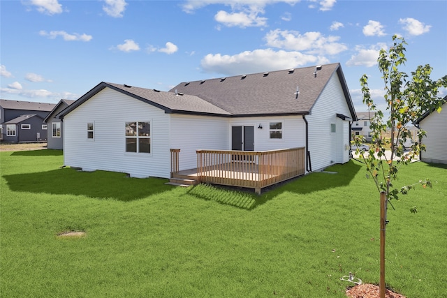 rear view of property with a lawn and a deck