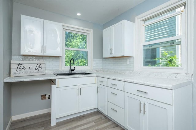 1613 York St, Des Moines, IA 50316 - kitchen with decorative backsplash, light wood-type flooring, white cabinetry, and recessed lighting