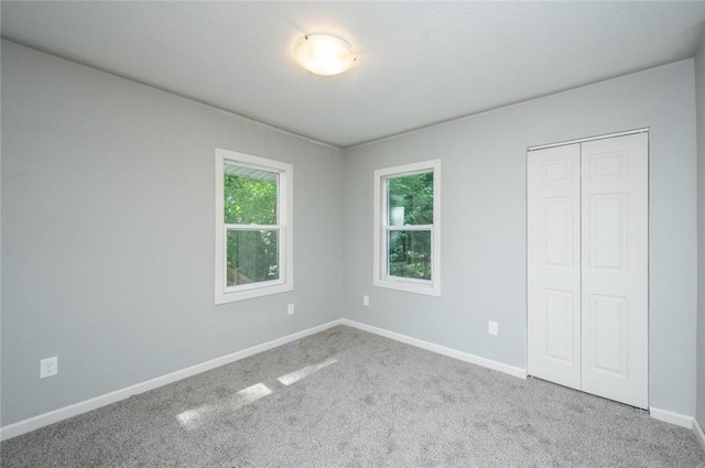 1613 York St, Des Moines, IA 50316 - unfurnished bedroom featuring carpet and a closet