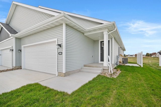 view of front facade featuring a garage, central air condition unit, and a front yard