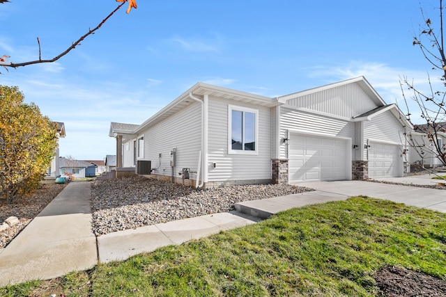 view of side of home featuring a lawn, a garage, and cooling unit