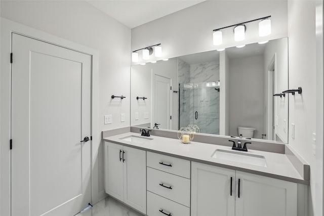 bathroom with vanity, toilet, and a shower with shower door