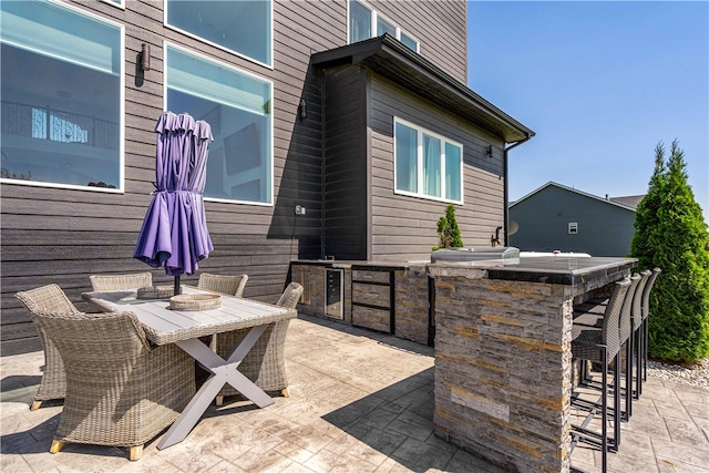 view of terrace featuring area for grilling and an outdoor bar