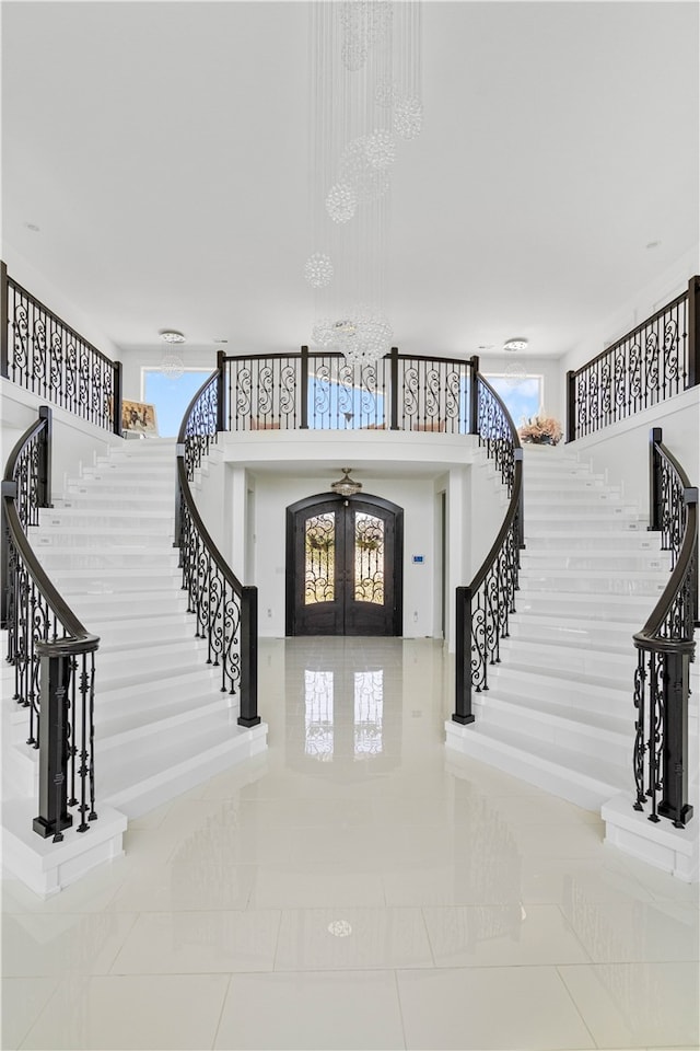 foyer entrance with plenty of natural light, french doors, and tile flooring