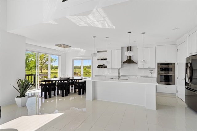 kitchen featuring double oven, wall chimney range hood, light tile flooring, and white cabinets