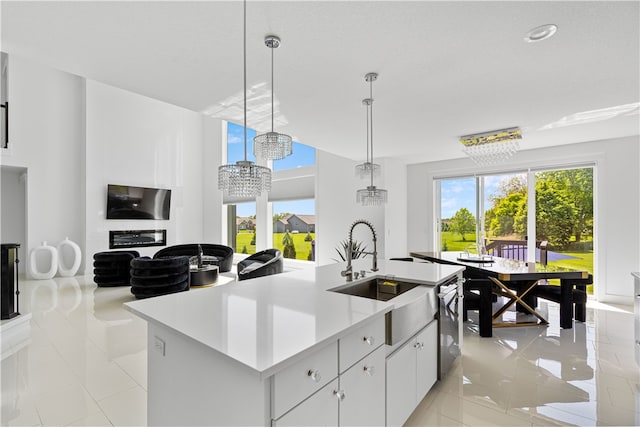 kitchen featuring a center island with sink, light tile floors, and pendant lighting