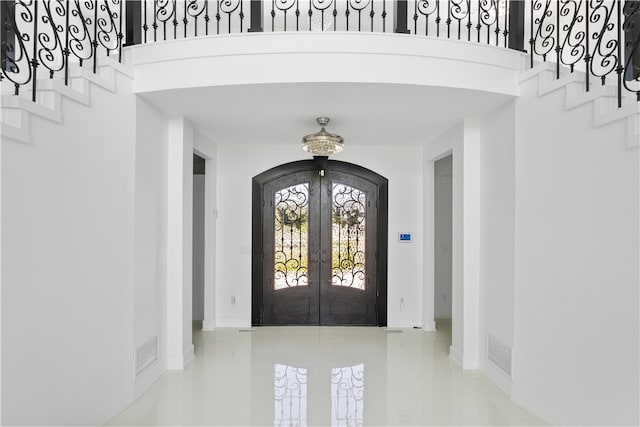 tiled entryway featuring french doors