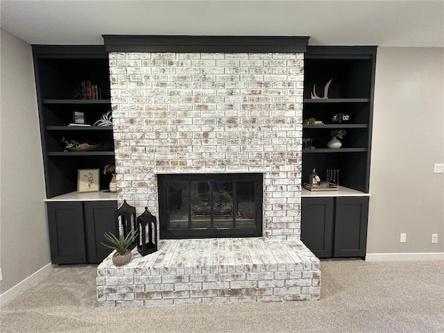 carpeted living room with a fireplace and built in features