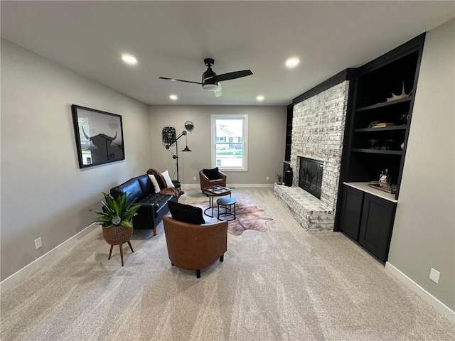 carpeted living room with a fireplace and ceiling fan