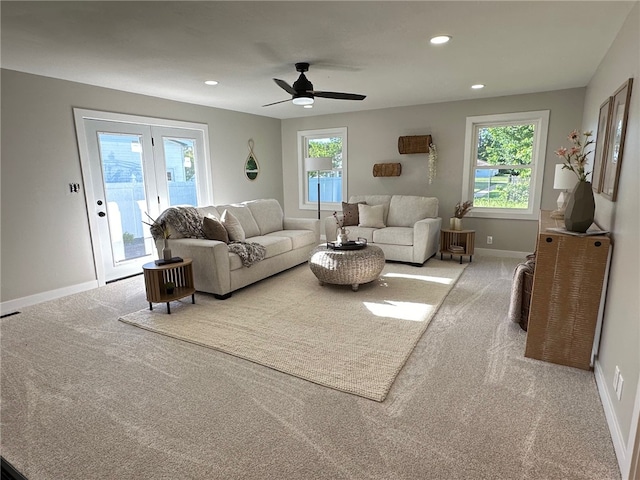 living room with ceiling fan and light colored carpet