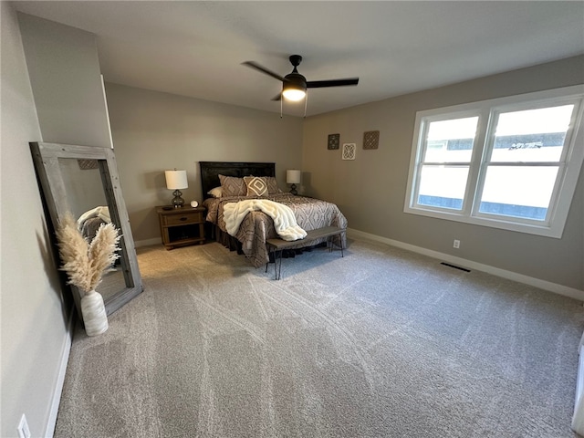 bedroom with ceiling fan and light colored carpet