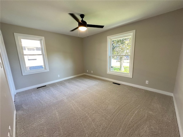 spare room with ceiling fan and carpet floors