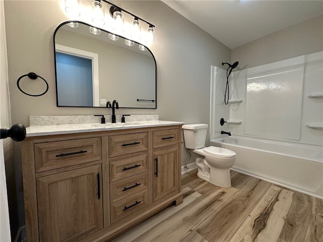 full bathroom with hardwood / wood-style floors, vanity, toilet, and shower / bathing tub combination